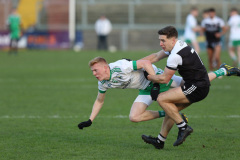 Burrens-Ronan-McGrath-takes-a-tumble-and-Kilcoos-Aaron-Branagan-tackles